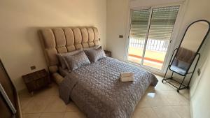 a bedroom with a large bed and a television at Appartement cosy in Agadir