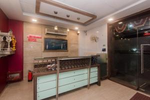 a room with a shelf with wine glasses at Super Hotel O Solitaire in Turambhe