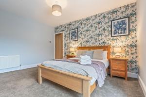 a bedroom with a bed with a wooden bed frame at Bay Apartment 2 in Morecambe