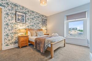a bedroom with a bed and a window at Bay Apartment 2 in Morecambe