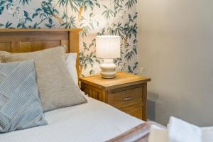 a bedroom with a bed and a lamp on a night stand at Bay Apartment 2 in Morecambe +16 photos