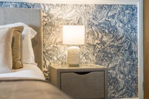 a lamp on a night stand next to a bed at Bay Apartment 2 in Morecambe