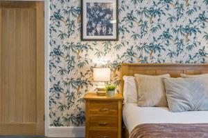 a bedroom with a bed and a table with a lamp at Bay Apartment 2 in Morecambe