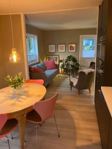 a living room with a table and a couch at Bright and central apartment in Stavanger