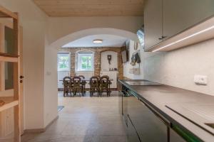 a kitchen and dining room with a table and chairs at Chata Ve Stopě in Boží Dar