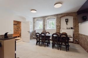 a kitchen and dining room with a table and chairs at Chata Ve Stopě in Boží Dar