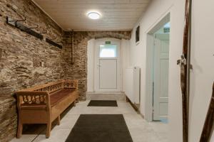 a hallway with a door and a wooden bench at Chata Ve Stopě in Boží Dar +41 photos