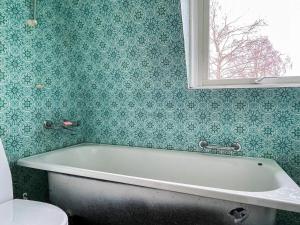a bath tub in a bathroom with a window at Holiday Home in Ruda with Terrace in Ruda +15 photos
