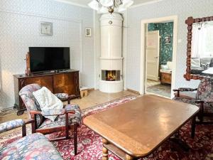 a living room with a table and a fireplace at Holiday Home in Ruda with Terrace in Ruda