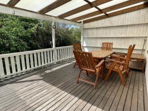 a wooden deck with a table and chairs on it at Holiday Home in Ruda with Terrace in Ruda