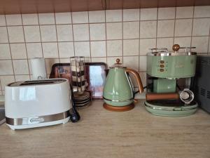 a group of appliances sitting on a kitchen counter at Vojtek Pince Vendégház in Villány