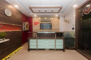 a restaurant with a counter in a room at Super Hotel O Solitaire in Turambhe
