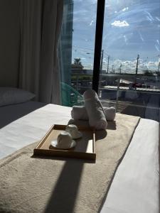 a hotel room with a bed with towels and a window at Riovale Container Lofts in Petrolina