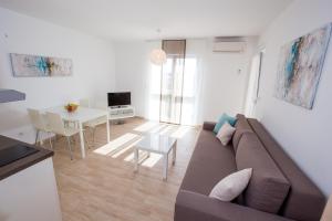 a living room with a couch and a table at Apartments Sesar in Rab