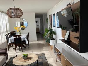 a living room with a table and a couch at NORTHSUITE - Vista al Mar - 3 Dormitorios - Parking in Antofagasta