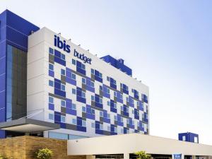 a blue and white building with a dogles hotel at Ibis Budget Farroupilha in Farroupilha