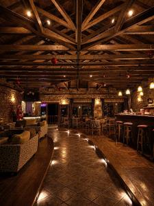 a bar with couches and tables in a room at Village Inn in Ano Chora