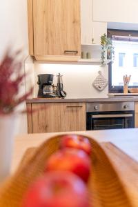 a kitchen with a cutting board with an apple on it at Moar Apartments in Silandro +11 photos