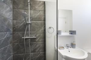 a bathroom with a shower and a sink at Flamingo Corbu Resort in Corbu +60 photos