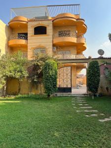 a building with a gate in front of a yard at Solis Pyramids View Hotel in Cairo