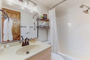 a bathroom with a sink and a toilet and a mirror at The Beech Hut in Beech Mountain +23 photos