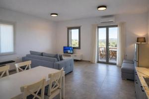 a living room with a couch and a table at Aroniadika rooms in Kythira