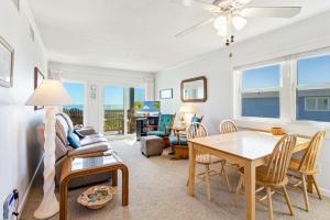 a living room with a table and a couch at AV2D - By The Sea in Nags Head