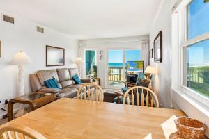 a living room with a couch and a table at AV2D - By The Sea in Nags Head +21 photos
