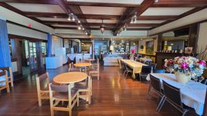 a restaurant with tables and chairs and a bar at Rodmay Heritage Hotel in Powell River