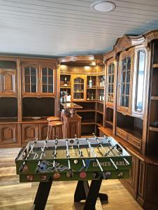 a room with a pool table in the middle of it at Lombada Villa Comfort in Ponta Delgada