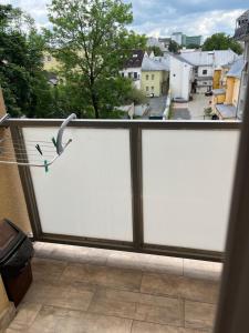 a white screen on a balcony with a bird on it at Urban Nest in the city center in Poprad
