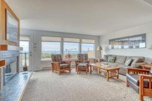 a living room with a couch and a table at Breakers Beach House 7 in Neskowin