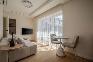 a living room with a couch and a table at Nida Breeze Apartments in Neringa