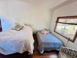 a bedroom with a large bed and a window at Oceana Suites Panguipulli in Panguipulli