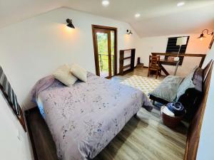 a bedroom with a bed and a chair and a piano at Oceana Suites Panguipulli in Panguipulli