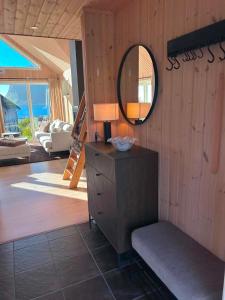 a mirror on the wall of a living room at Haukland beach panorama - with Sauna in Offersøya