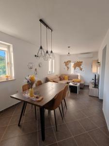 a dining room and living room with a table at Počitniška hiša Kuferland in Dobrovnik