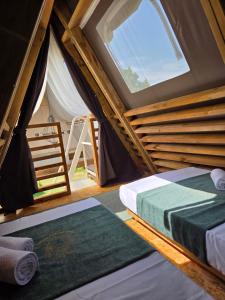 a room with two beds and a window at Green Glamping Paravia in Krasica +71 photos