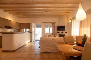 a living room with a couch and a table at Infinity View Villas Mykonos in Kalo Livadi