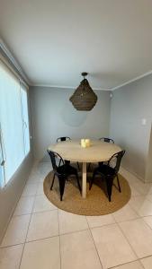 a dining room with a table and two chairs at casa mar in Playa Unión +2 photos