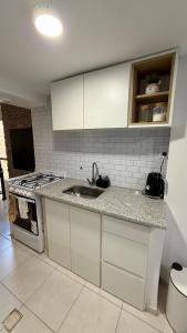 a kitchen with a sink and a stove at casa mar in Playa Unión