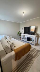 a living room with a bed and a flat screen tv at casa mar in Playa Unión