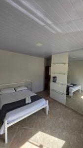 a bedroom with a bed and a dresser at Pousada Serra do Sol in Mariana +16 photos
