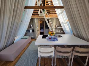 a small white table and chairs in a room at Green Glamping Paravia in Krasica