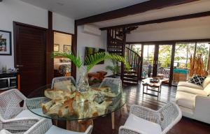 a living room with a glass table and chairs at 4 Elements - Contadora Island in Contadora