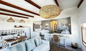 a living room with white furniture and two beds at Duneberry Beach Studio in Yzerfontein
