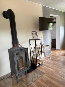 a fireplace in a living room with a stove at Chata Snowee Valča in Stará Turá