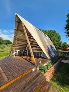 a tent with a table and chairs on a deck at Green Glamping Paravia in Krasica