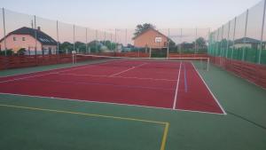 a tennis court with a net on top of it at Thomas home in Homole