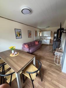a living room with a table and a couch at Chata Snowee Valča in Stará Turá